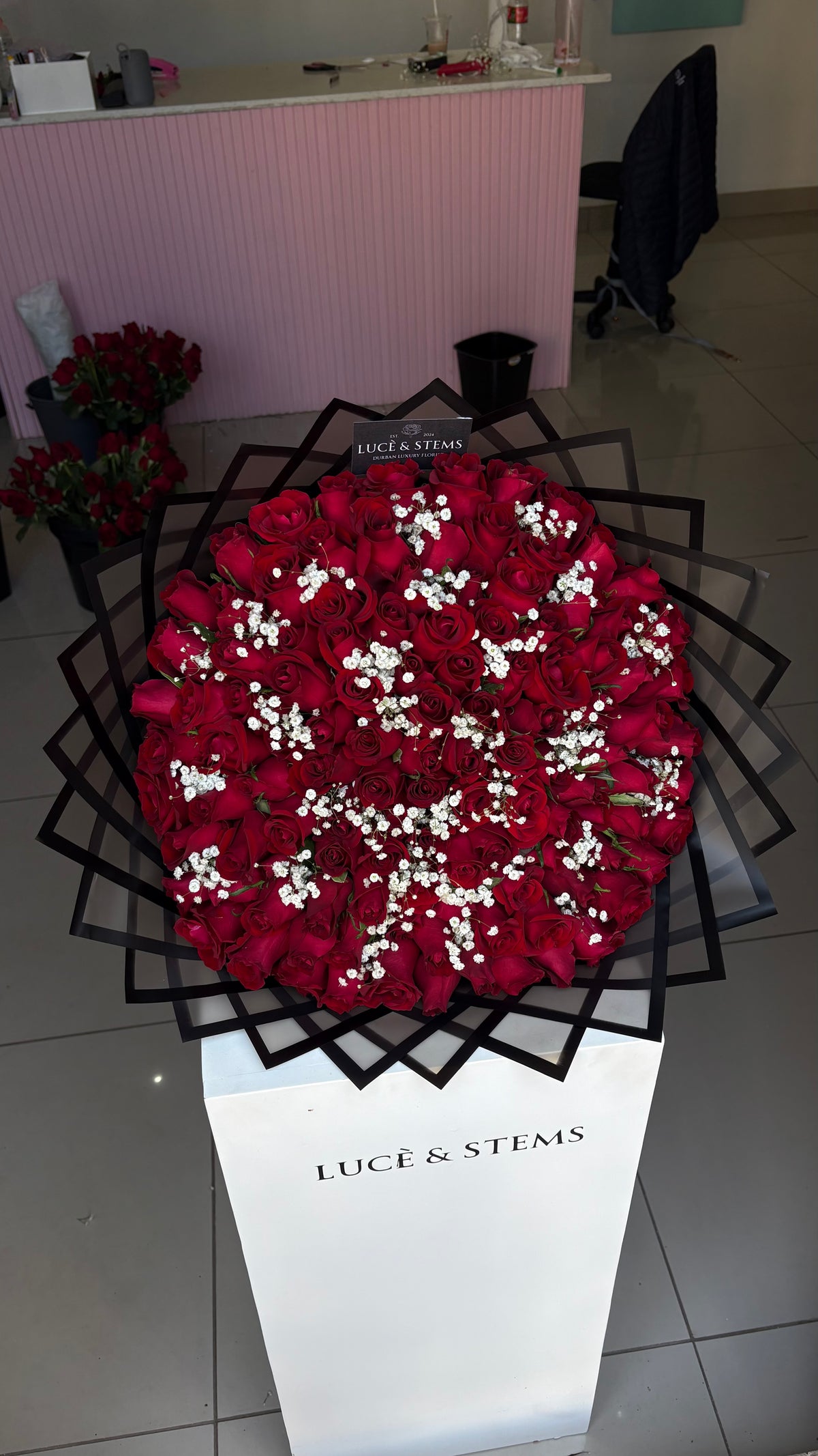 Red roses with baby’s breath in between
