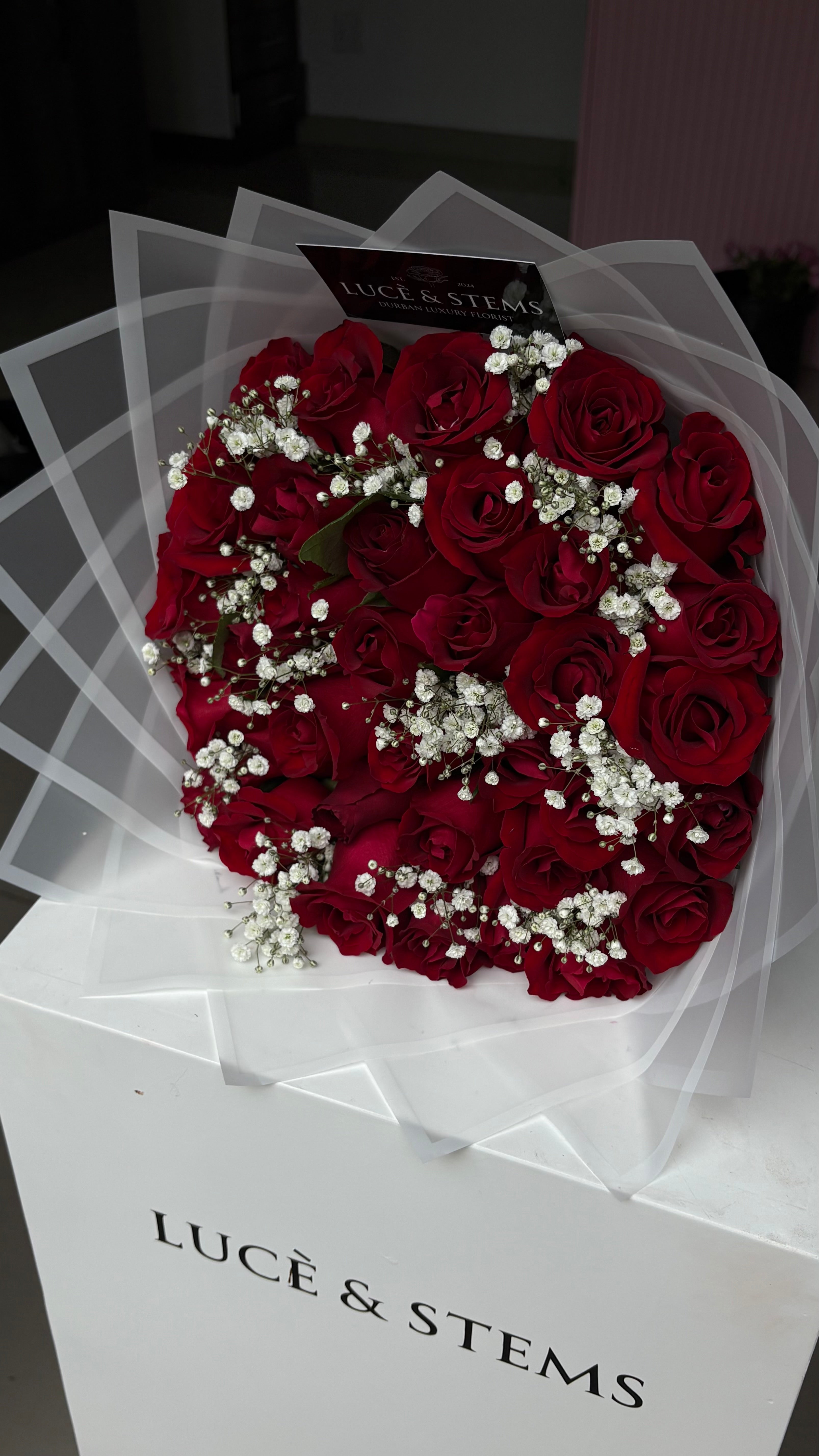 Red roses with baby’s breath in between
