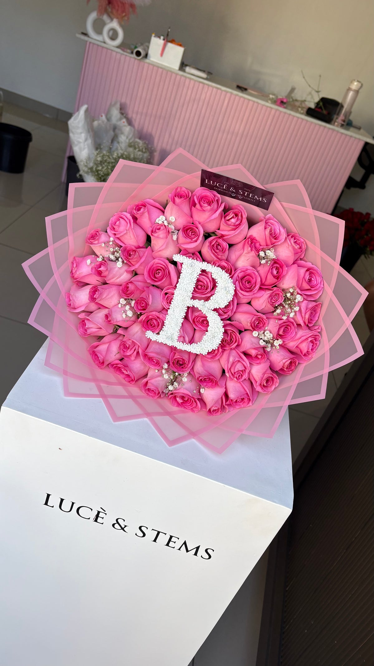 Pink Rose bouquets with an initial and baby’s breath