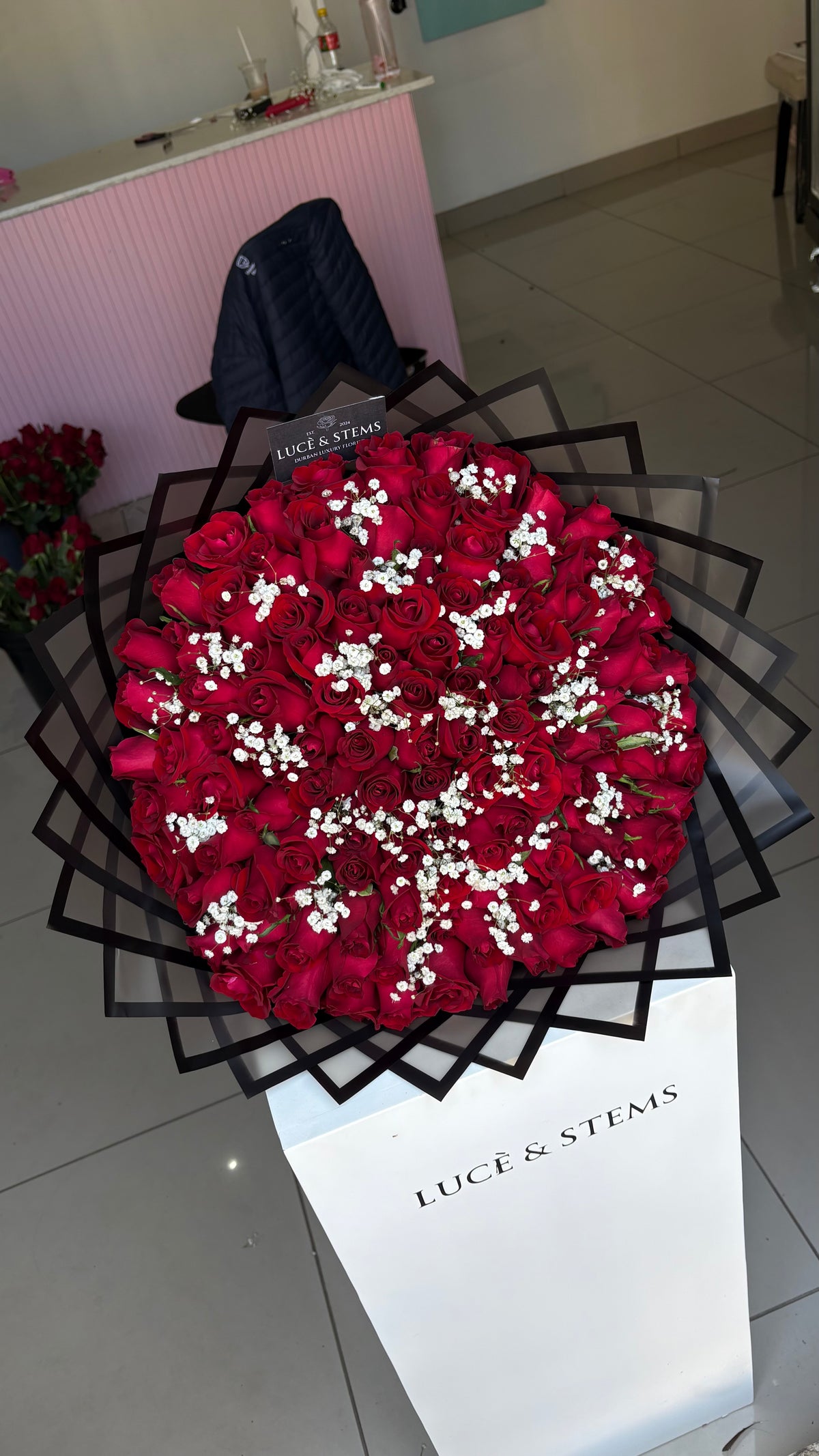 Red roses with baby’s breath in between