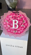 Pink Rose bouquets with an initial and baby’s breath