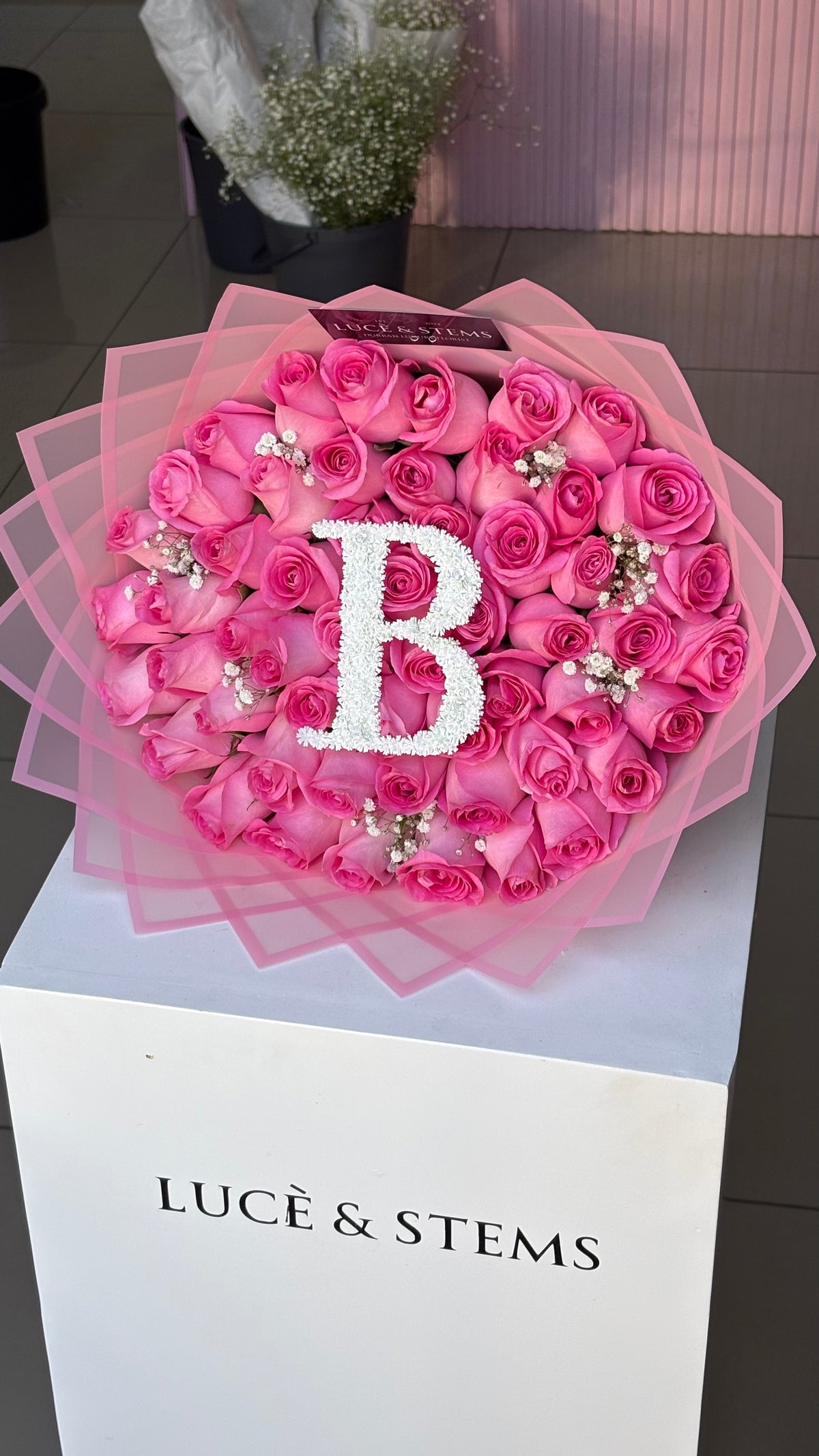 Pink Rose bouquets with an initial and baby’s breath