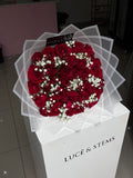 Red roses with baby’s breath in between